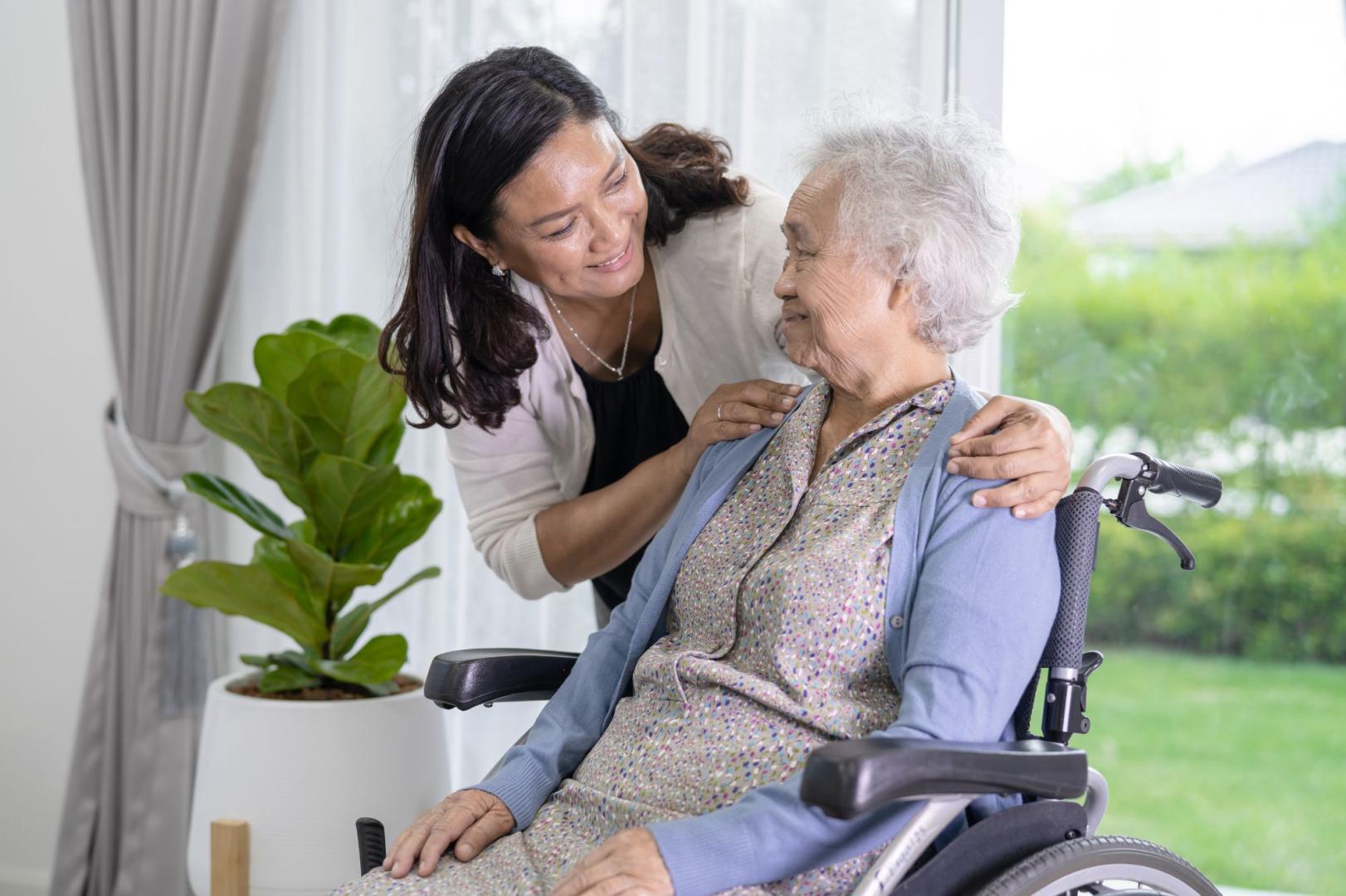 Woman in a wheelchair with caregiver