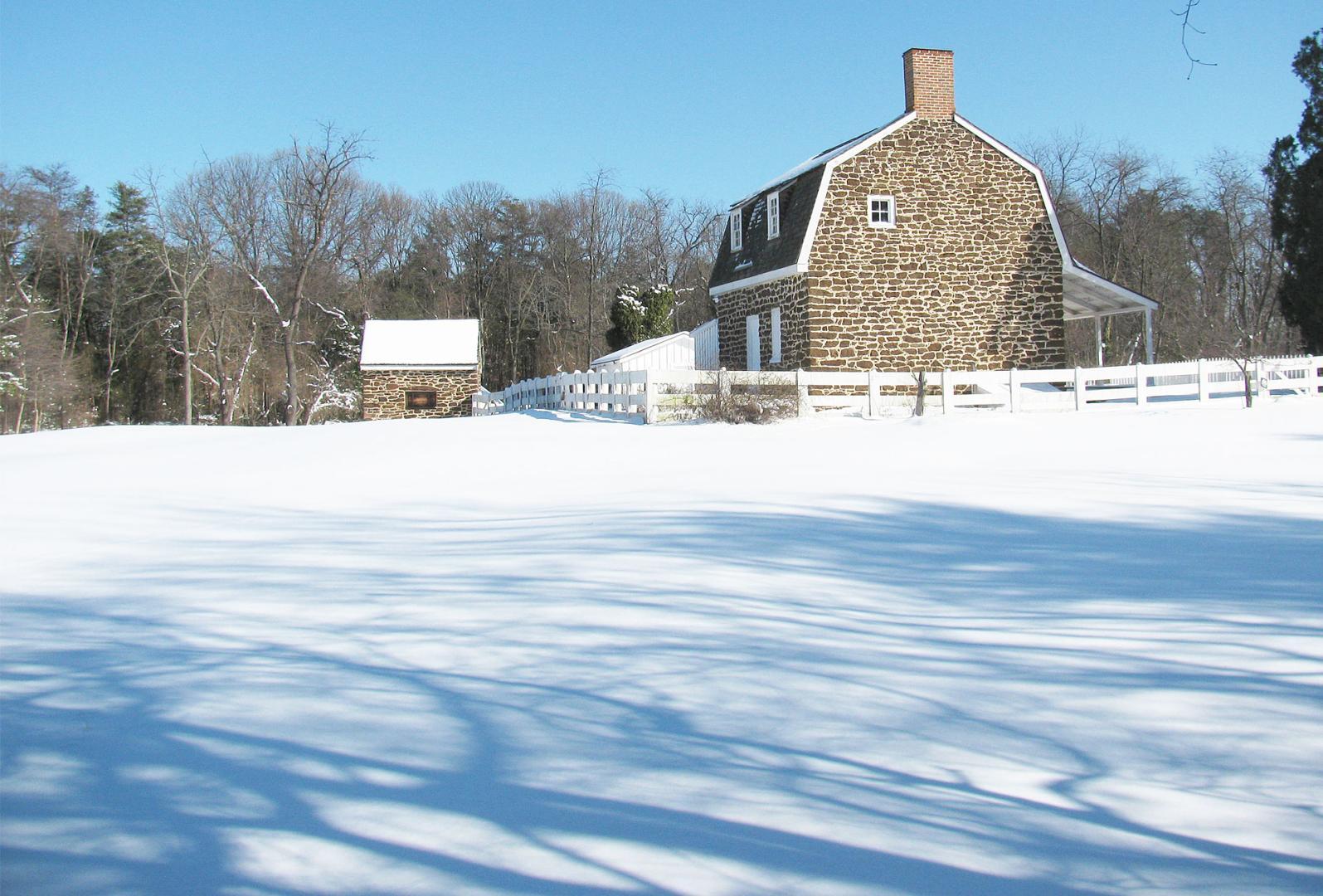 A house in a field of snow during winter