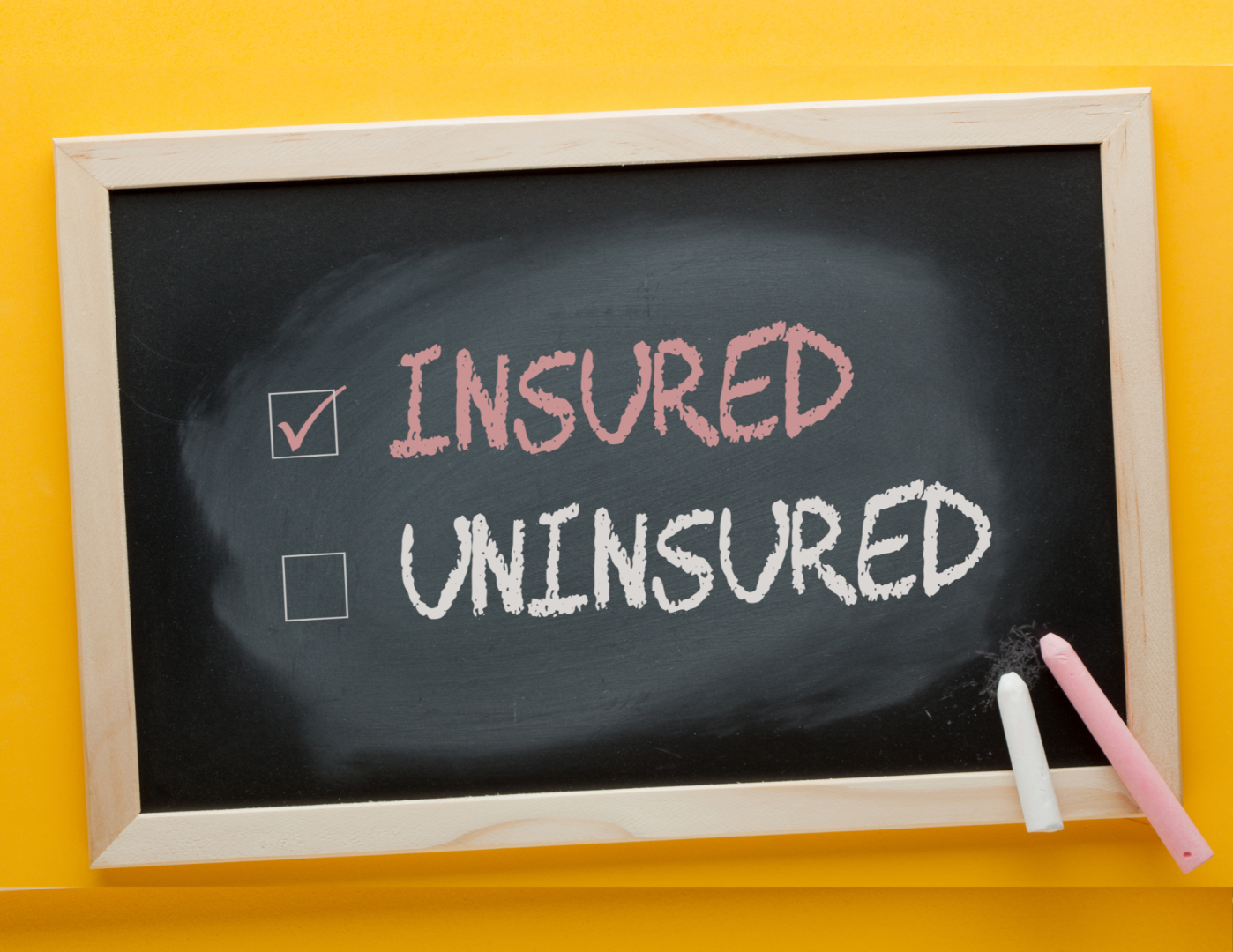 A chalkboard with Insured and uninsured written in it. Insured is checked
